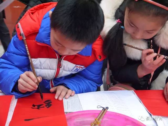 九龙小学学生正在写春联